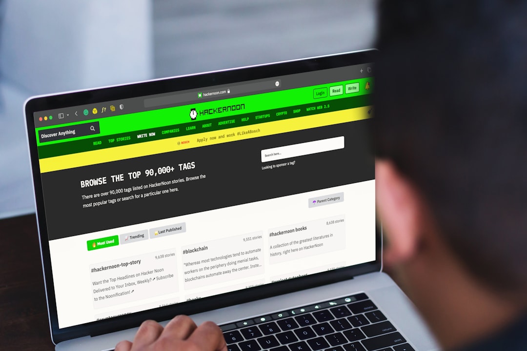 Man reading HackerNoon stories and browsing top technology tag pages.